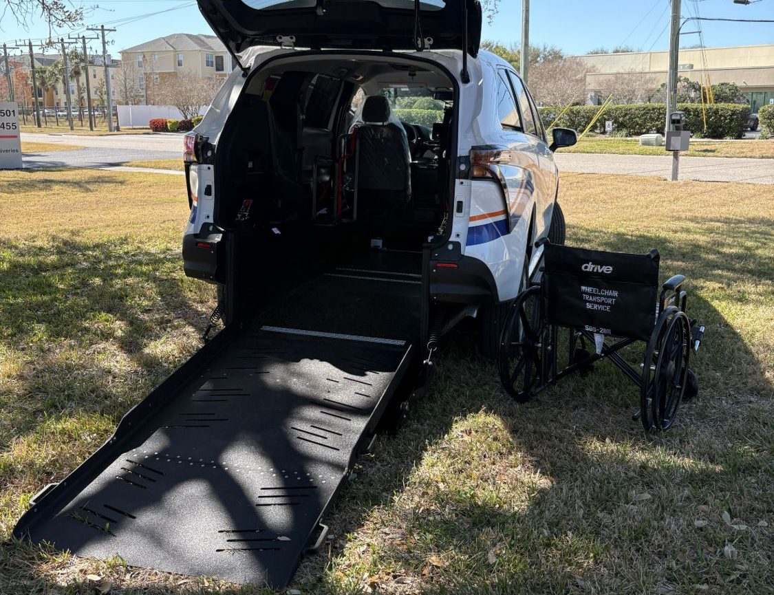 WTS wheelchair-accessible van with rear ramp lowered and a wheelchair
